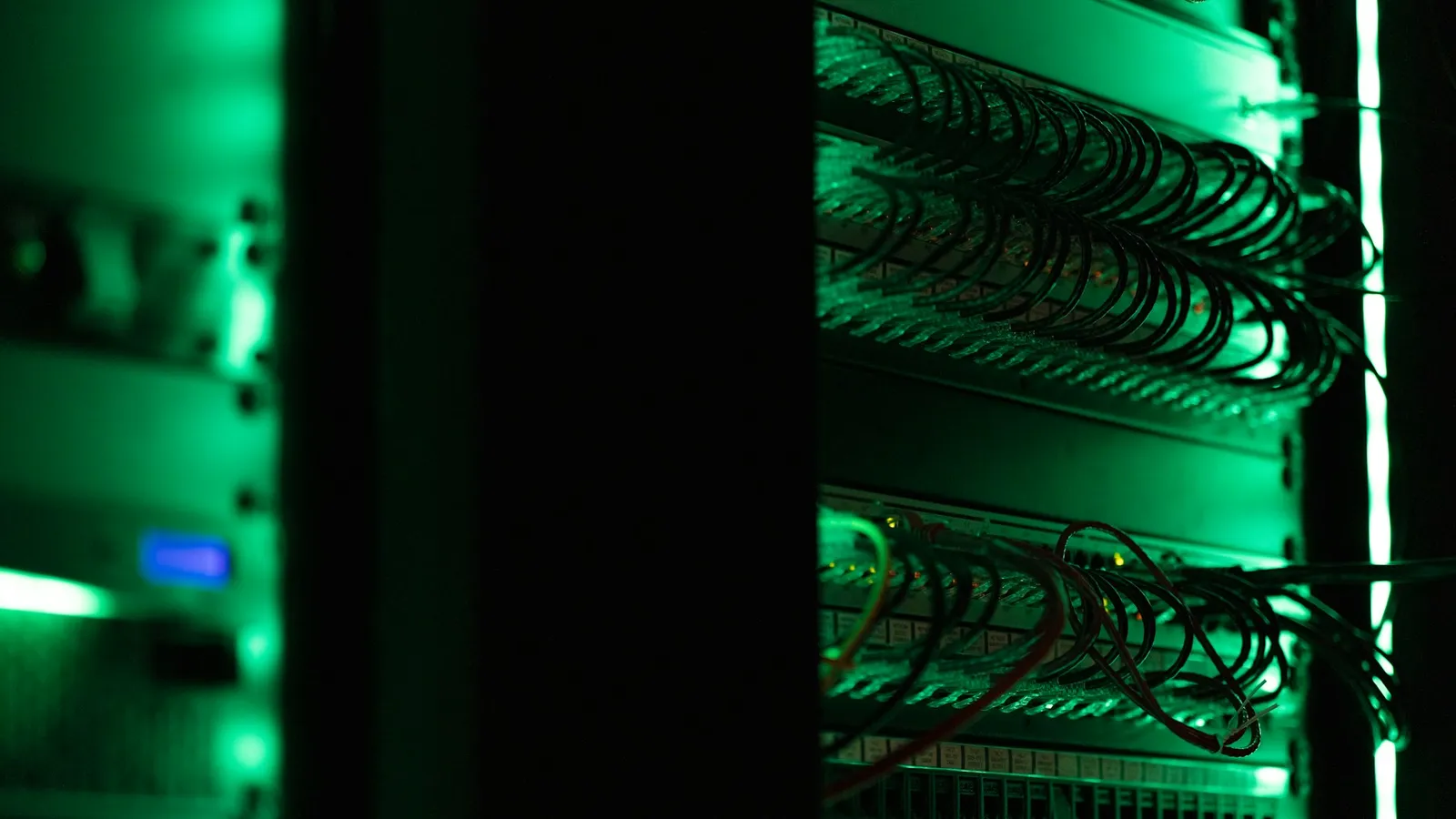 Rows of servers in a dark data centre
